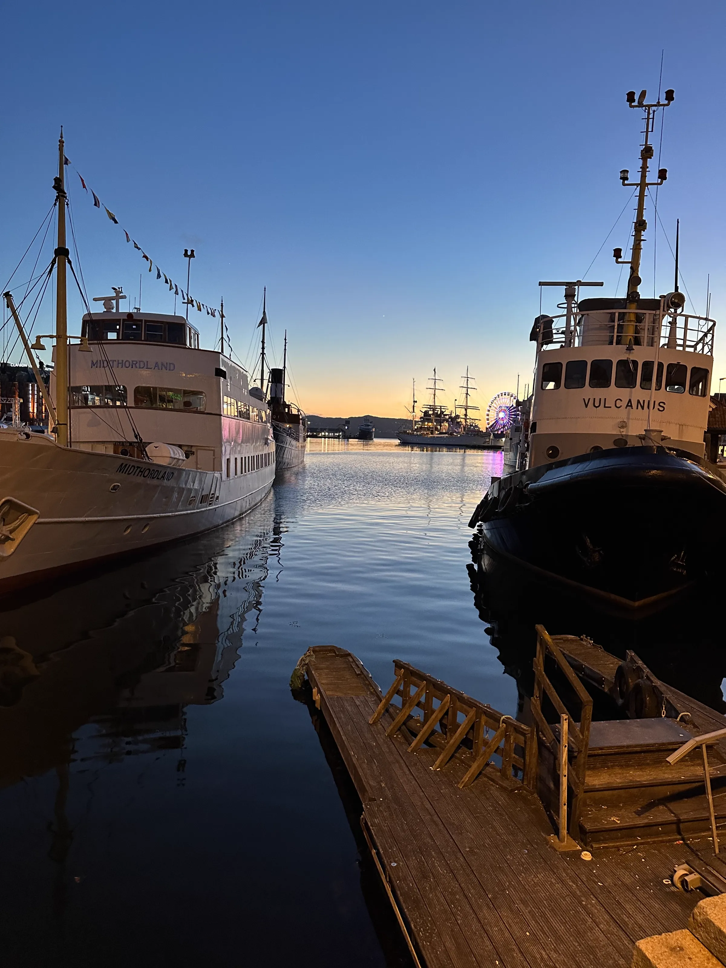 Bergen harbour bathed in warm orange and pink sunset colours