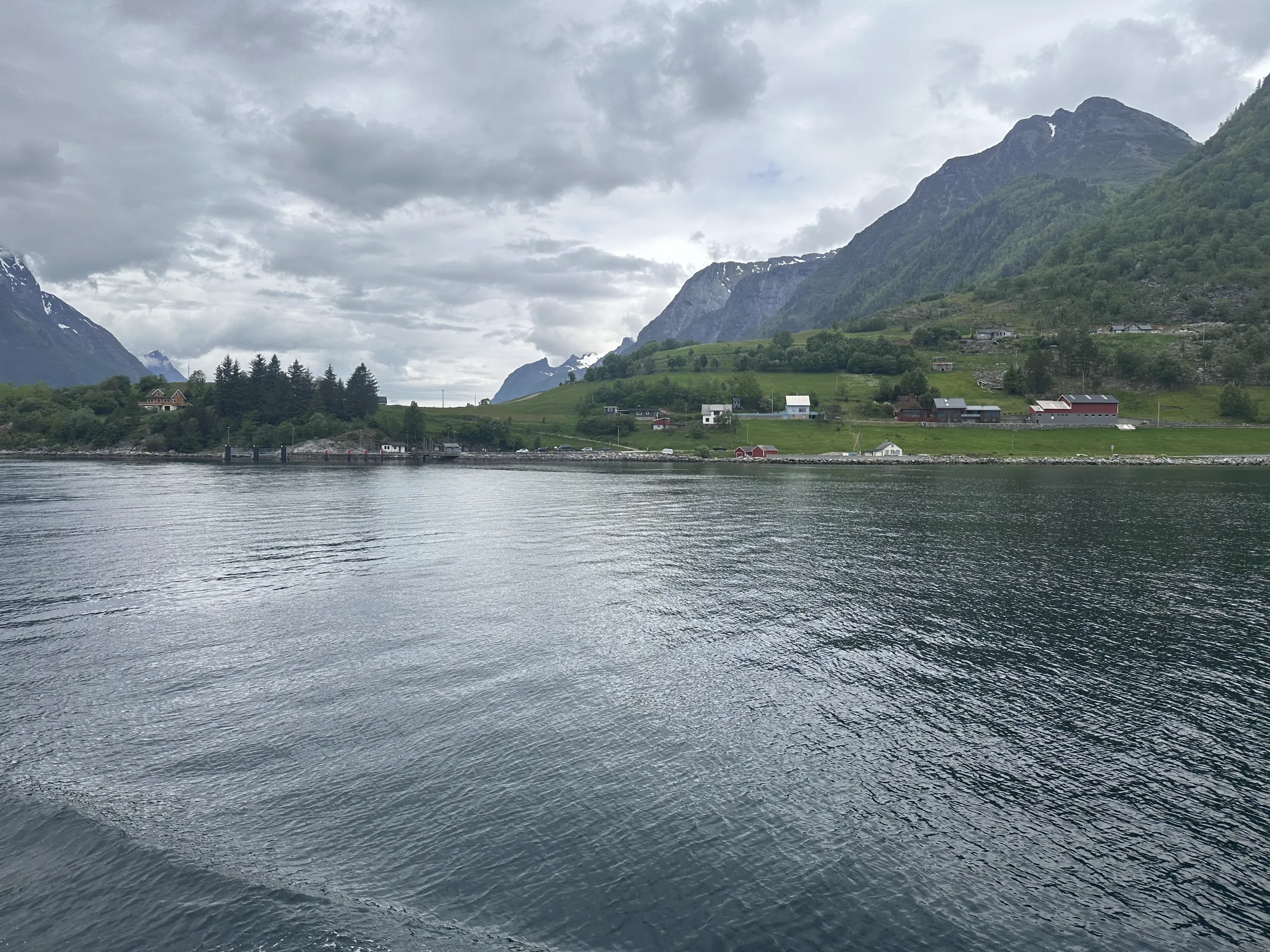 A small Norwegian village nestled at the foot of steep fjord mountains