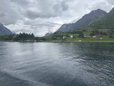 A small Norwegian village nestled at the foot of steep fjord mountains