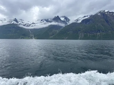 Wide fjord vista with snowy mountains receding into the distance on a spring day