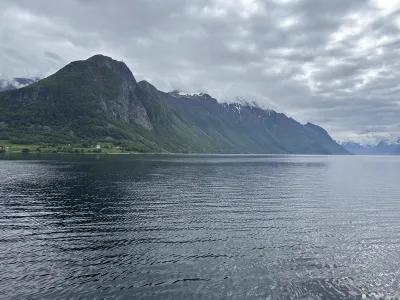 Entrance to the fjord with a massive mountain ridge stretching into the clouds