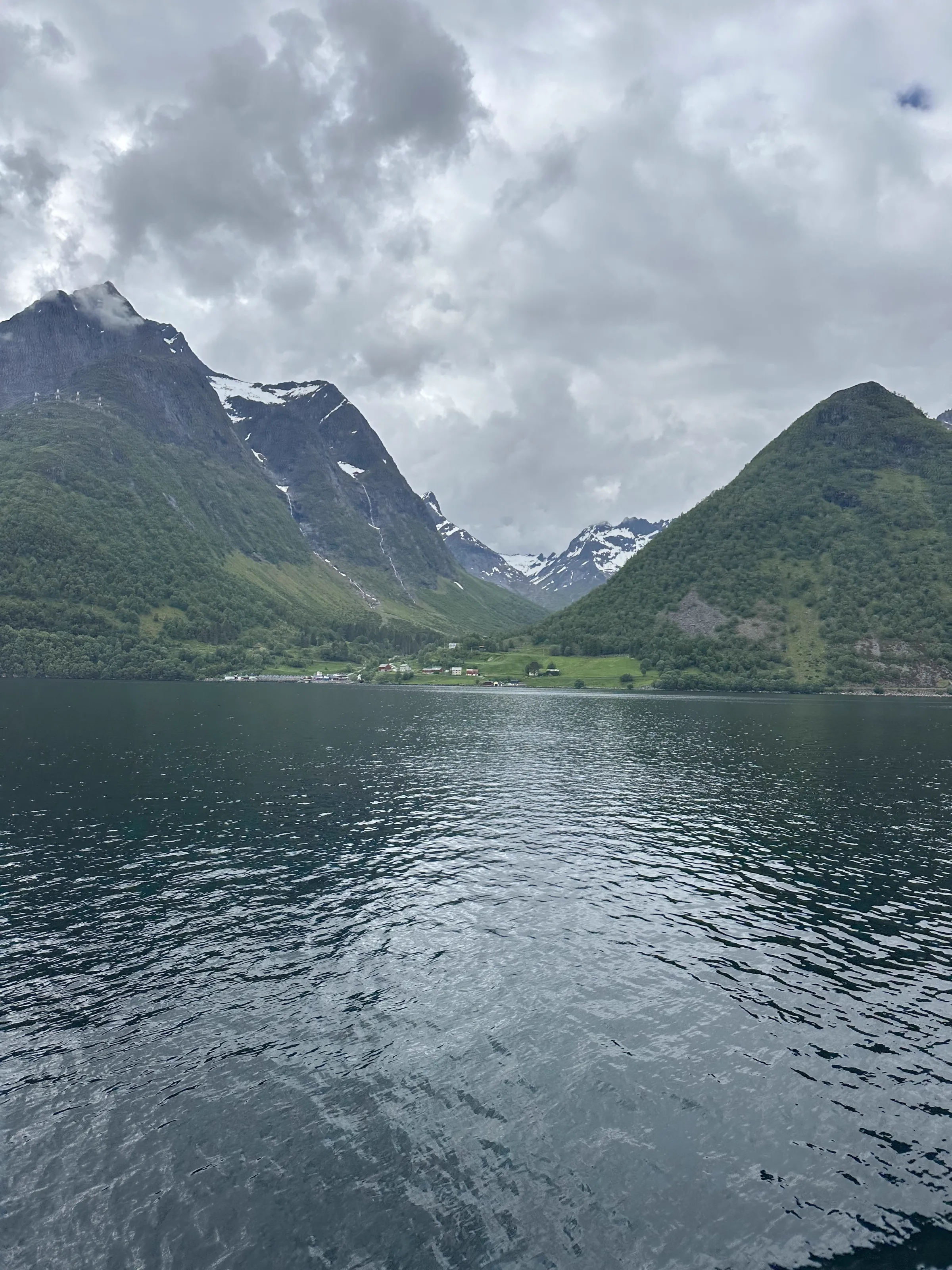 A village on the shore in a valley between two mountain peaks