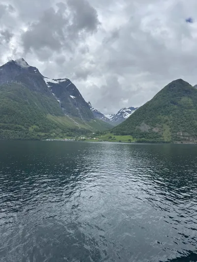 A village on the shore in a valley between two mountain peaks