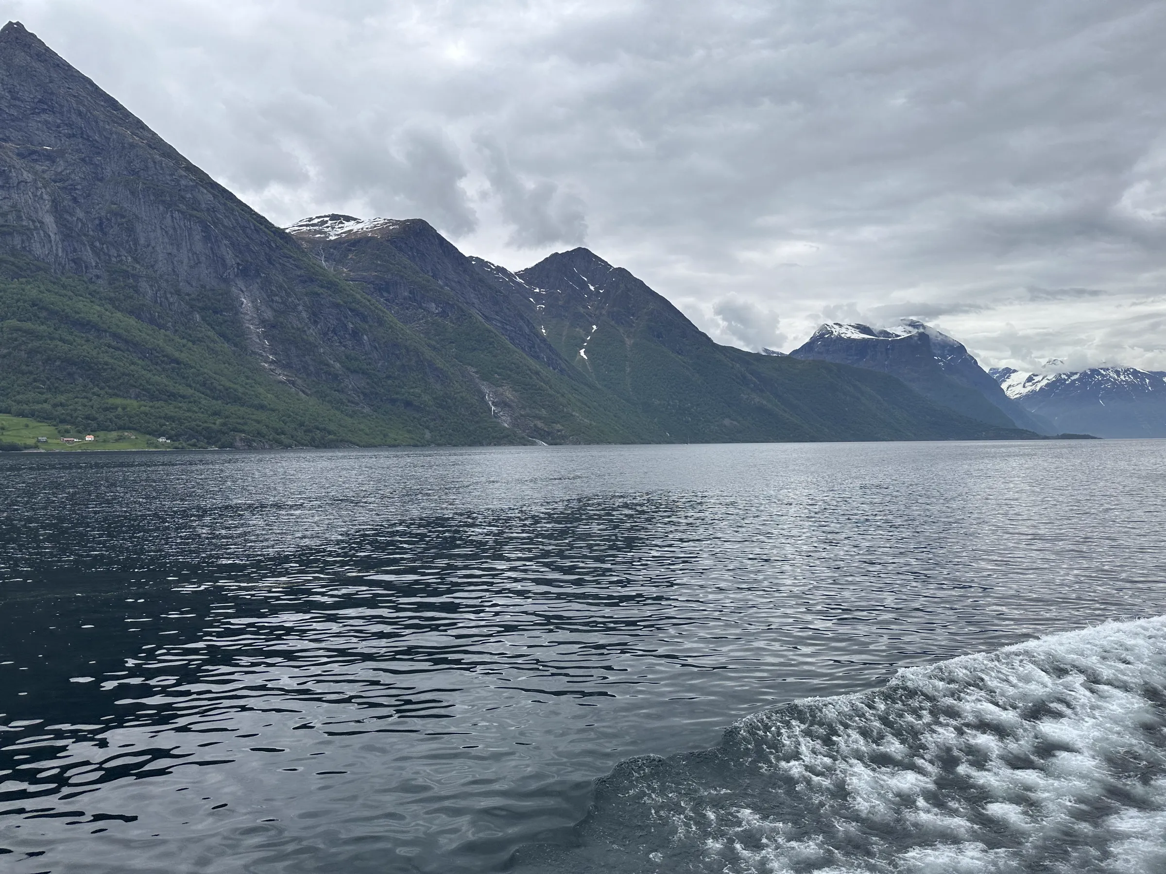 Spring fjord landscape with snow still visible on the distant mountain peaks