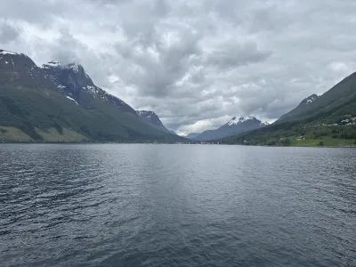 A wide fjord passage with towering cliffs rising steeply on both sides