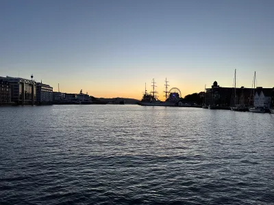 Warm sunset hues washing over Bergen harbour and the surrounding hills