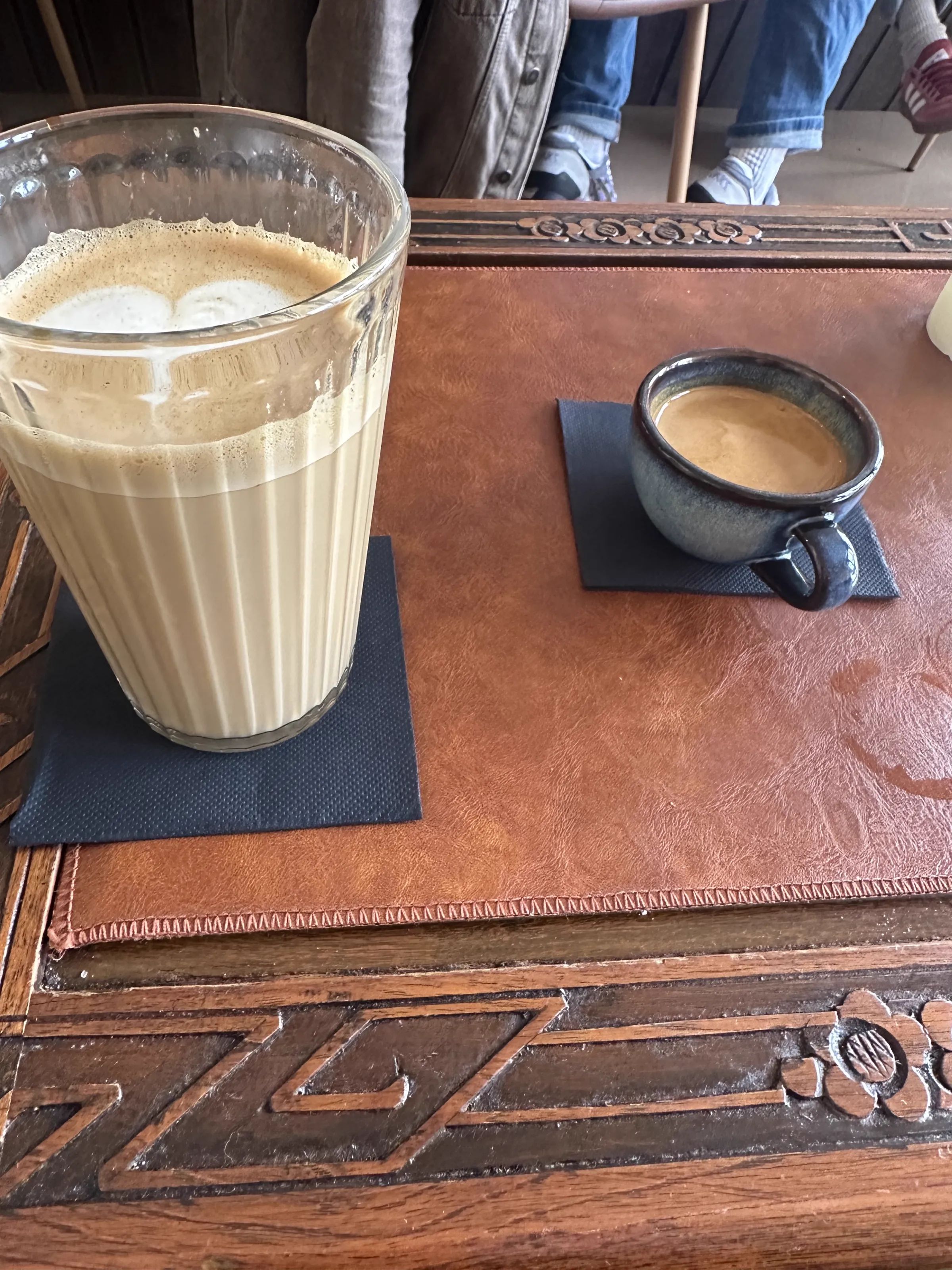 An oat milk latte and espresso on a table at Café Mash in Bergen
